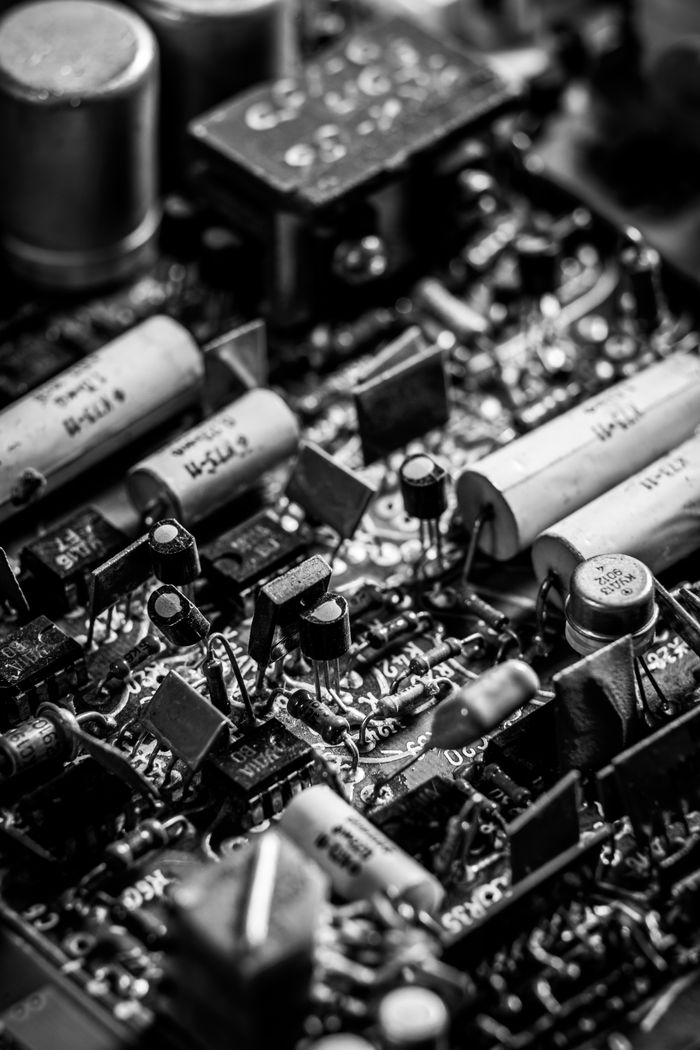 Detailed grayscale photo of electronic circuit board components.